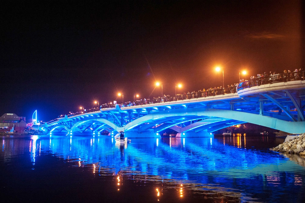 The construction of the Kenneth F. Burns Memorial Bridge was a complex and high-profile project that replaced a structurally deficient, 7-span concrete arch bridge built in 1916 with 2 new bridges over Lake Quinsigamond, between Worcester and Shrewsbury, MA. The new bridges are 870’ long, 5-span open spandrel steel deck arches founded on 36” diameter pipe piles up to 290’ deep. The project also included reconstructed portions of Lake Avenue and Route 9 and contains many architectural features.